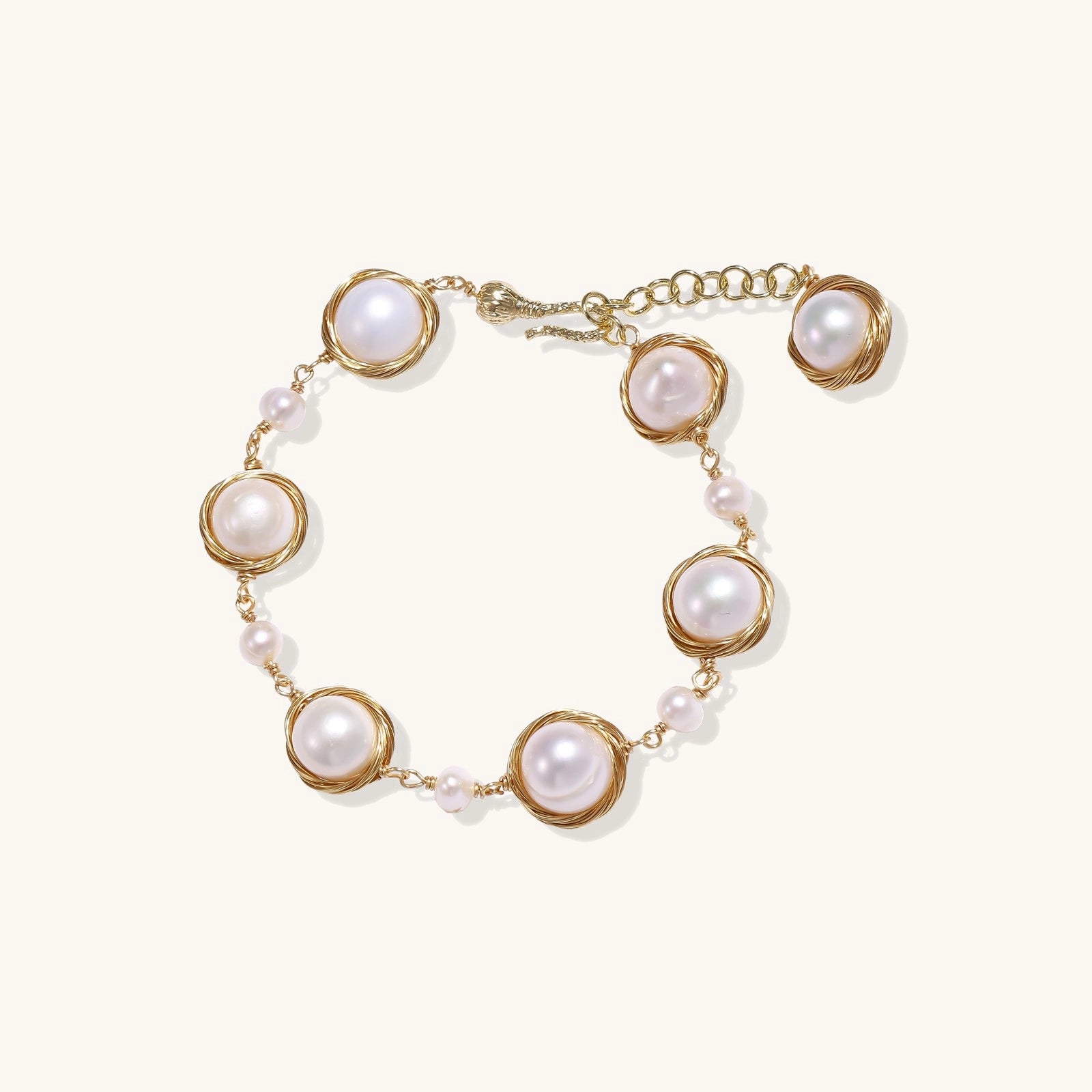 14K gold plated bracelet featuring wire-wrapped freshwater pearls in nest-like settings with adjustable chain closure