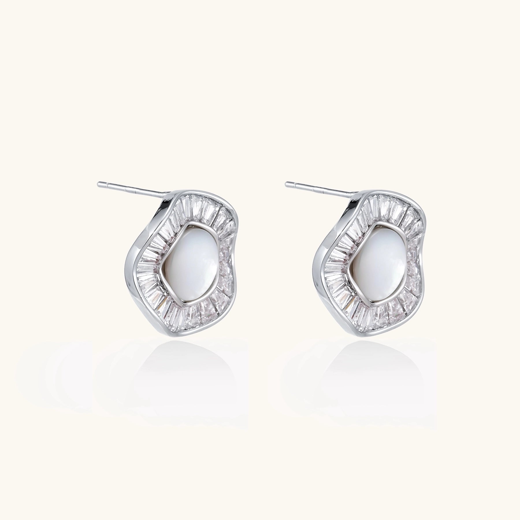 Gold-plated stud earrings with central freshwater pearl surrounded by baguette crystals in radial pattern