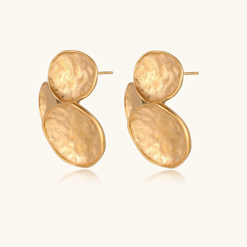 Sculptural gold-plated stainless steel earrings with three hammered oval shapes arranged in artistic cluster formation